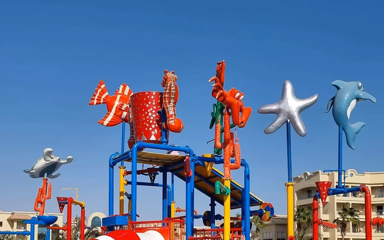 Een kleurrijk speeltoestel met glijbaan, zeesterren en dolfijnen van kunststof in een kinderzwembad